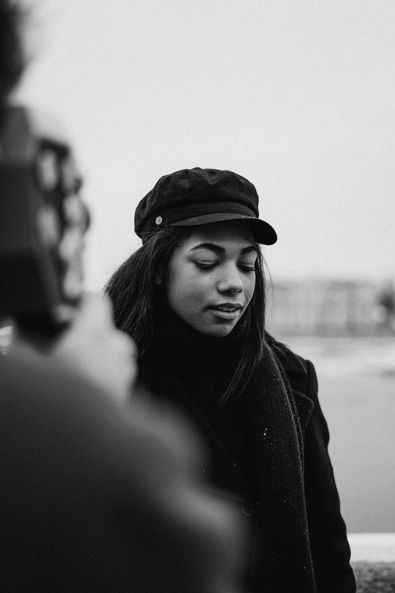 Grayscale Photo of Woman in Black Coat and Black Hat